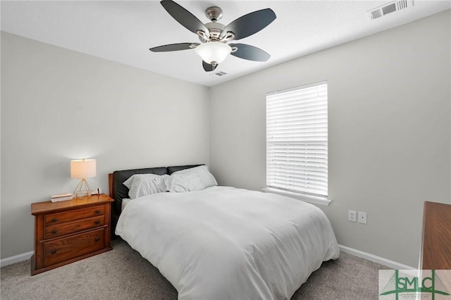 carpeted bedroom featuring visible vents, multiple windows, and baseboards