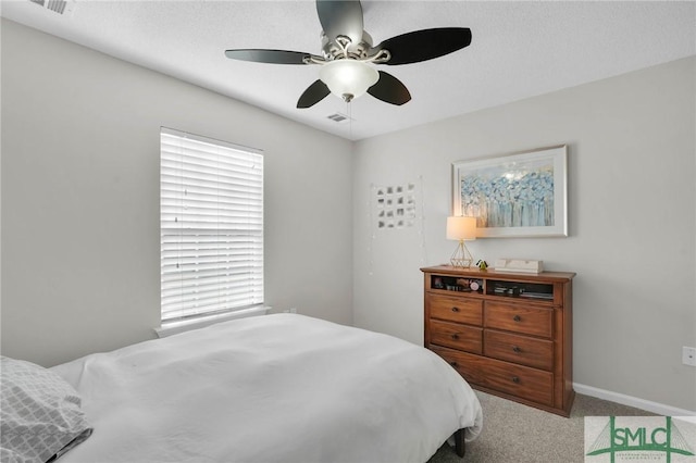 bedroom featuring a ceiling fan, carpet, visible vents, and baseboards