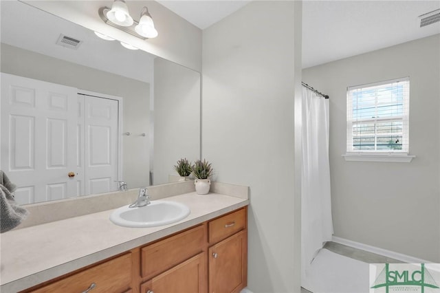 bathroom featuring visible vents and vanity
