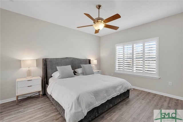 bedroom with ceiling fan, baseboards, and wood finished floors
