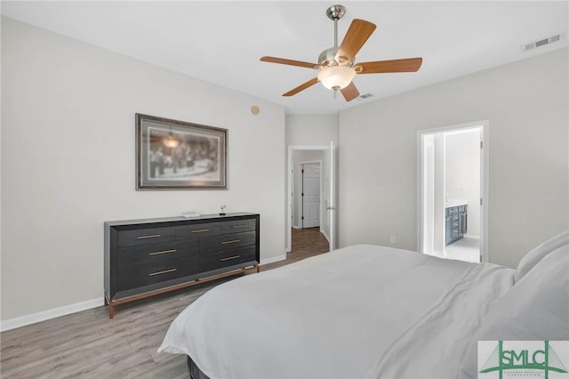 bedroom featuring light wood finished floors, visible vents, connected bathroom, and baseboards