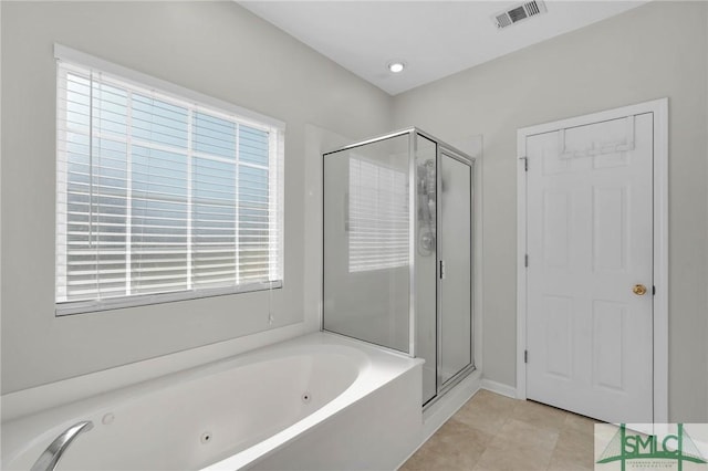 bathroom with tile patterned floors, a jetted tub, visible vents, and a stall shower