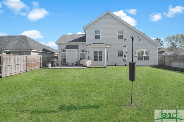 rear view of property with a fenced backyard, a patio area, and a yard