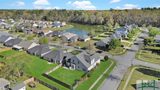aerial view featuring a residential view, a forest view, and a water view