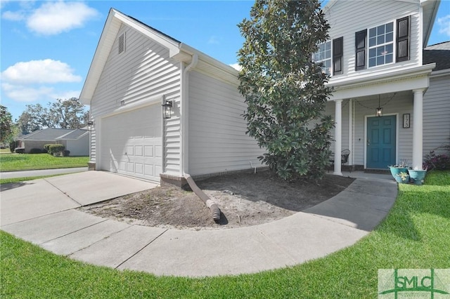 view of front of home with covered porch, concrete driveway, and a front yard