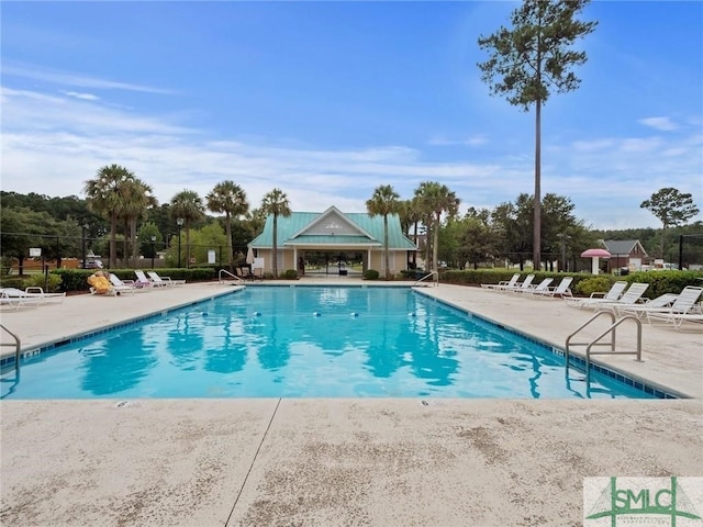 community pool featuring a patio and fence