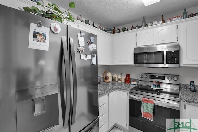 kitchen featuring stone counters, stainless steel appliances, a textured ceiling, and white cabinets