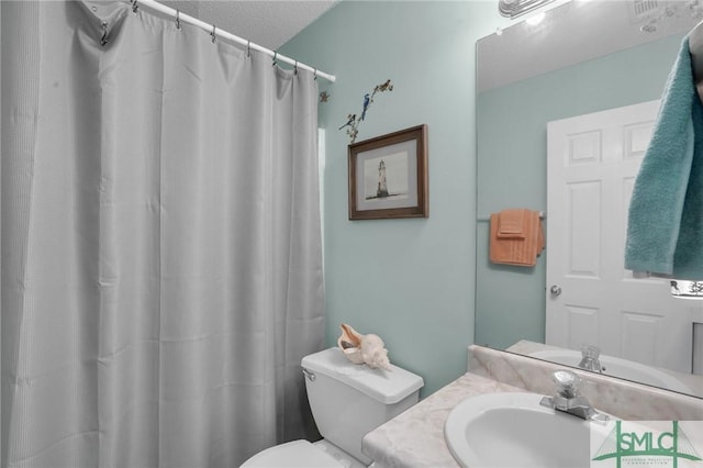 bathroom featuring a shower with shower curtain, toilet, and vanity