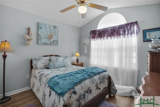 bedroom with ceiling fan, baseboards, lofted ceiling, and wood finished floors