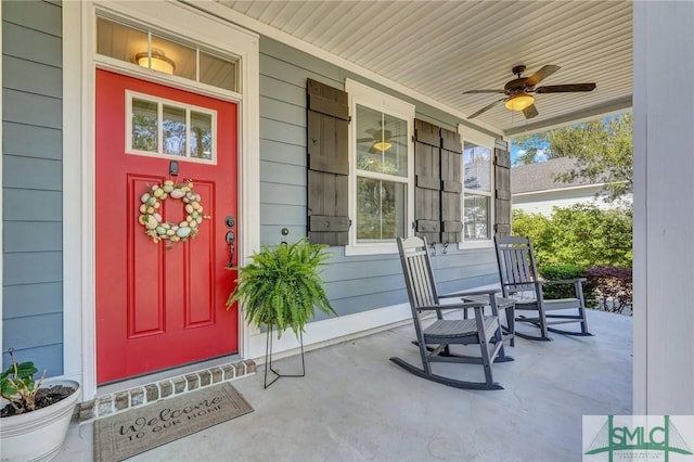 doorway to property featuring a porch and ceiling fan