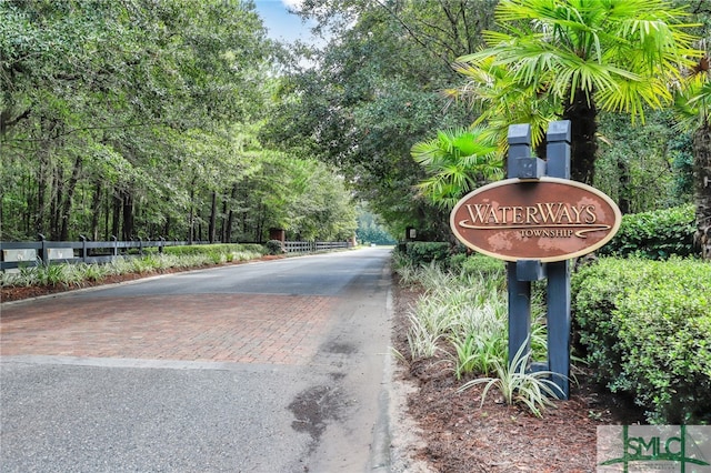 community sign featuring decorative driveway