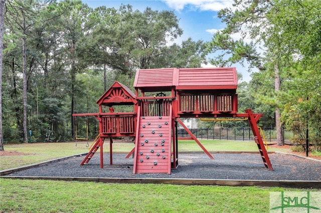 view of jungle gym featuring a lawn and fence