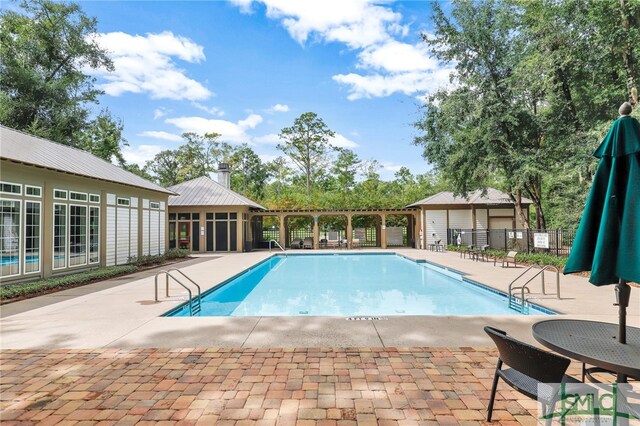 pool featuring fence and a patio area