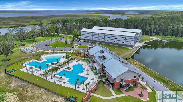 drone / aerial view featuring a forest view and a water view