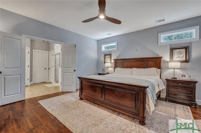 bedroom with visible vents, ceiling fan, and dark wood-style floors