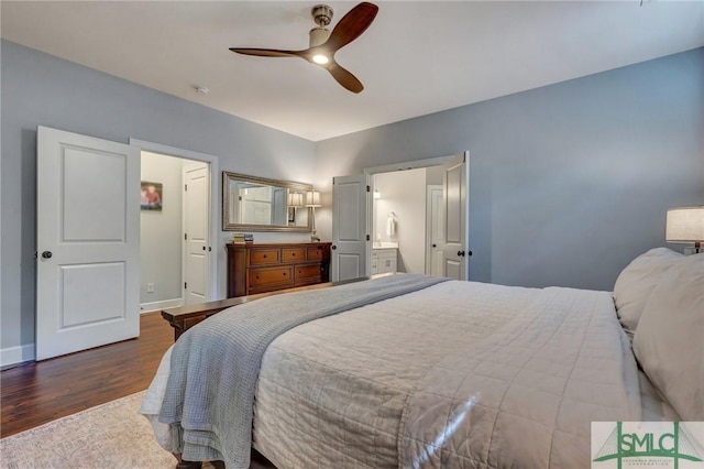 bedroom with baseboards, wood finished floors, a ceiling fan, and connected bathroom