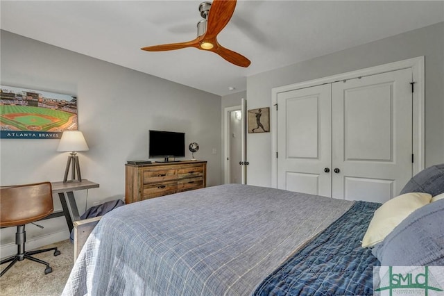 bedroom with a closet, carpet flooring, a ceiling fan, and baseboards