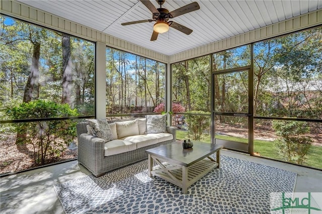 sunroom with an outdoor living space and a ceiling fan