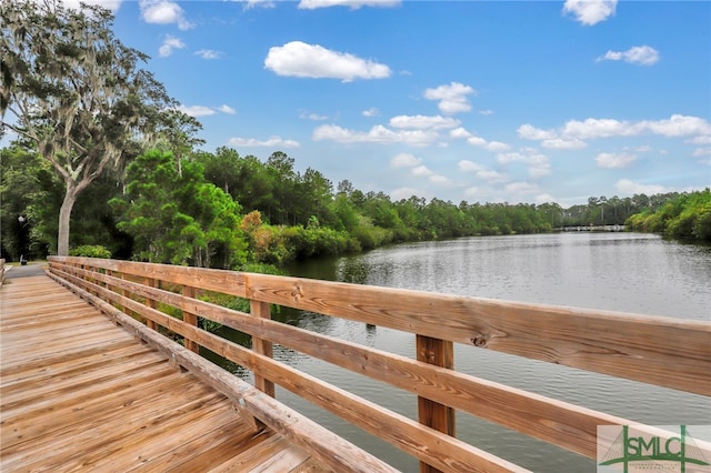 dock area featuring a water view and a view of trees
