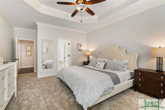 bedroom featuring a tray ceiling, light carpet, crown molding, a ceiling fan, and baseboards