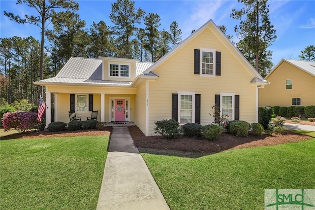 103 Cornerstone Dr, Springfield, GA 31329 - view of front of property with covered porch, a front lawn, and a metal roof