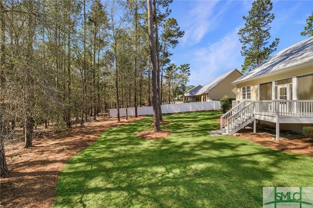 view of yard featuring a wooden deck and stairway