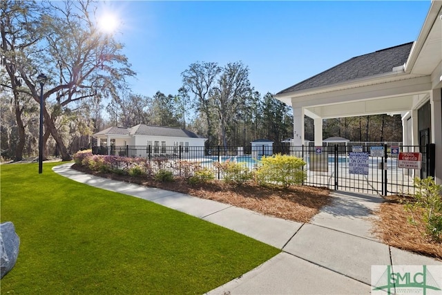 view of yard featuring a community pool and fence