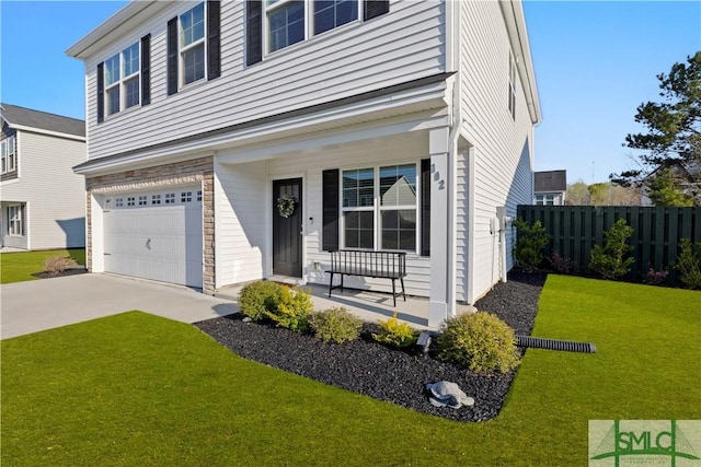 view of front facade with a front yard, fence, driveway, a porch, and an attached garage