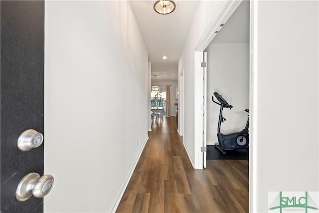 hall featuring wood finished floors and baseboards