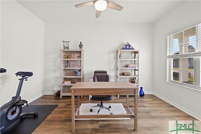home office with a ceiling fan, wood finished floors, and baseboards