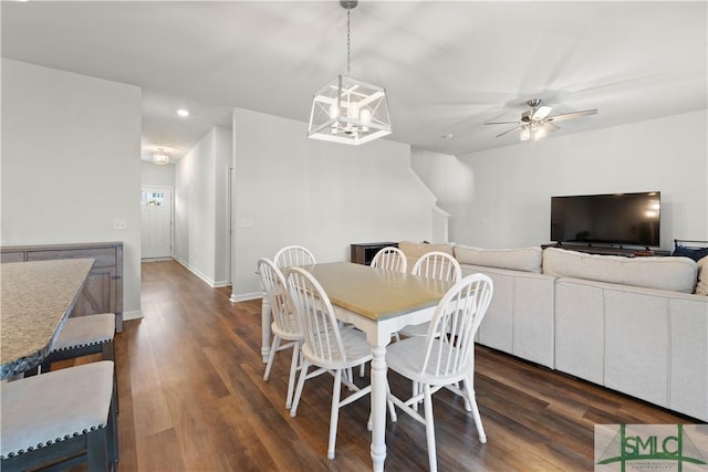 dining space with recessed lighting, baseboards, dark wood finished floors, and ceiling fan with notable chandelier
