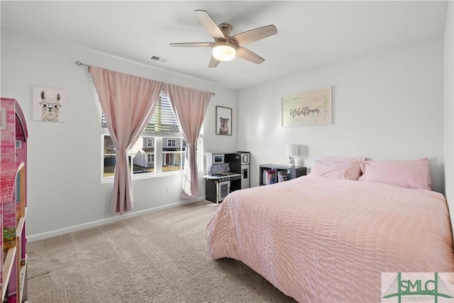 carpeted bedroom with a ceiling fan, baseboards, and visible vents