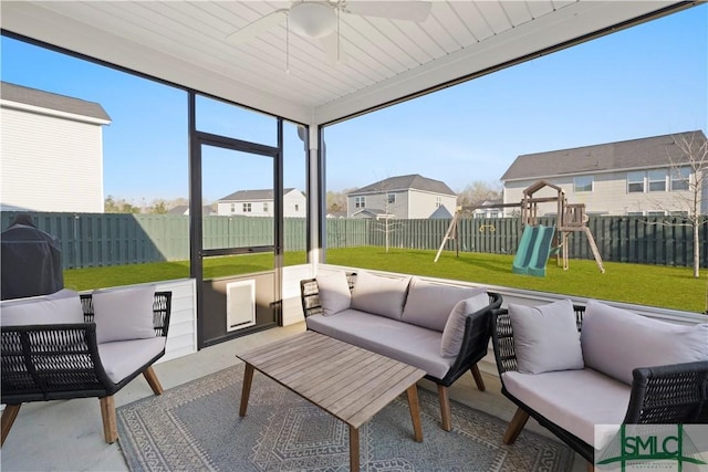 sunroom with plenty of natural light, an outdoor living space, and a ceiling fan