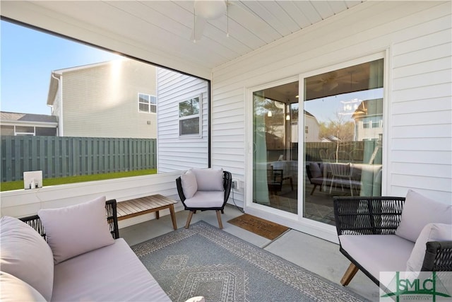 view of patio / terrace with a ceiling fan and fence