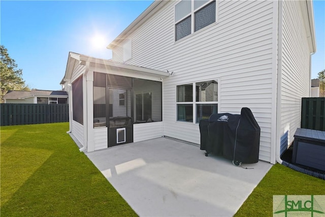 rear view of property with a patio area, a lawn, a fenced backyard, and a sunroom