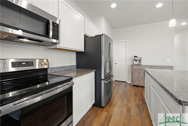 kitchen with dark wood finished floors, stone countertops, white cabinetry, and stainless steel appliances