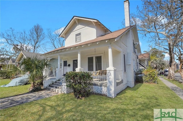 916 E 34th St, Savannah, GA 31401 - bungalow-style house featuring a front lawn, covered porch, and a chimney