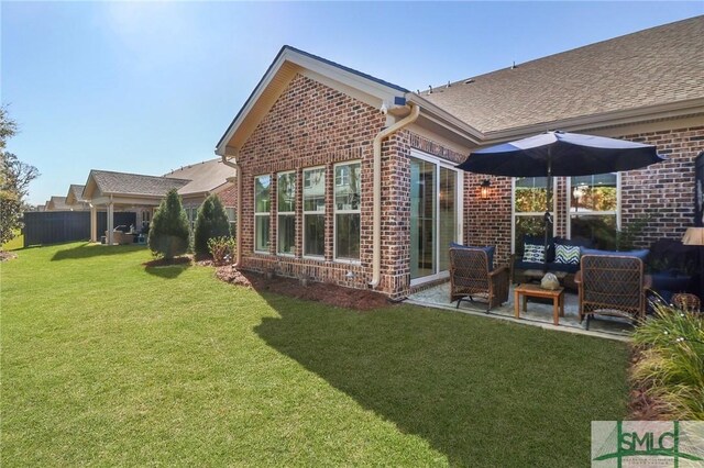 117 Hope Ln Unit A, Savannah, GA 31406 - back of property featuring brick siding, outdoor lounge area, a shingled roof, and a patio area