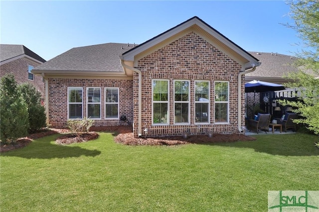 117 Hope Ln Unit A, Savannah, GA 31406 - back of property featuring brick siding, a yard, and roof with shingles