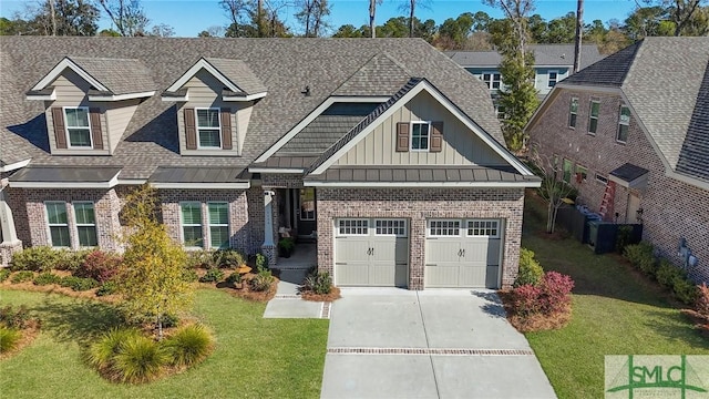 117 Hope Ln Unit A, Savannah, GA 31406 - view of front facade with brick siding, driveway, board and batten siding, and a front yard