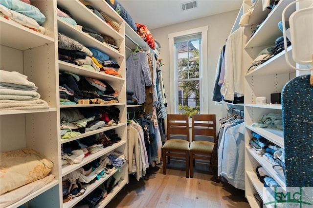 spacious closet featuring visible vents and wood finished floors