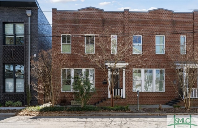 view of property featuring brick siding