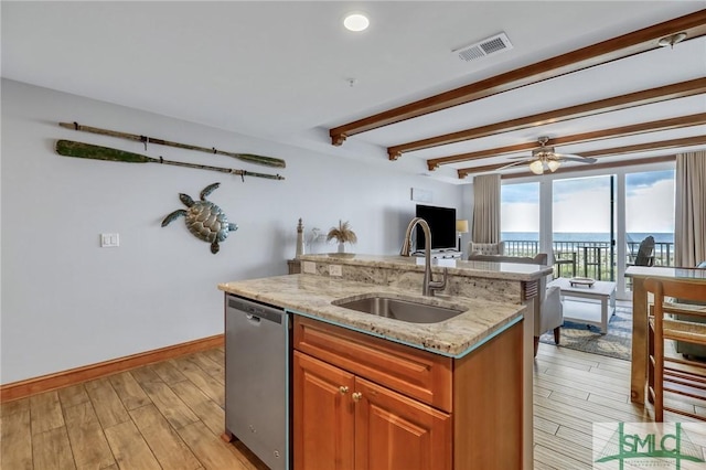 kitchen with visible vents, open floor plan, dishwasher, light wood-type flooring, and a sink