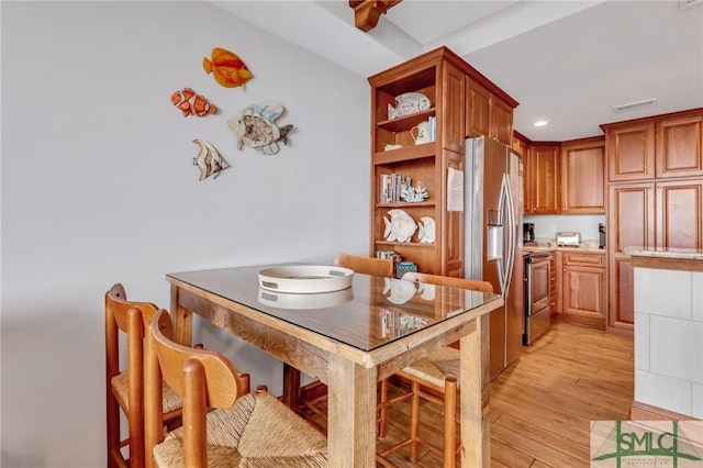 kitchen with visible vents, open shelves, light wood-style flooring, appliances with stainless steel finishes, and brown cabinets