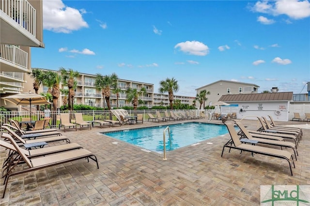 community pool featuring a patio and fence