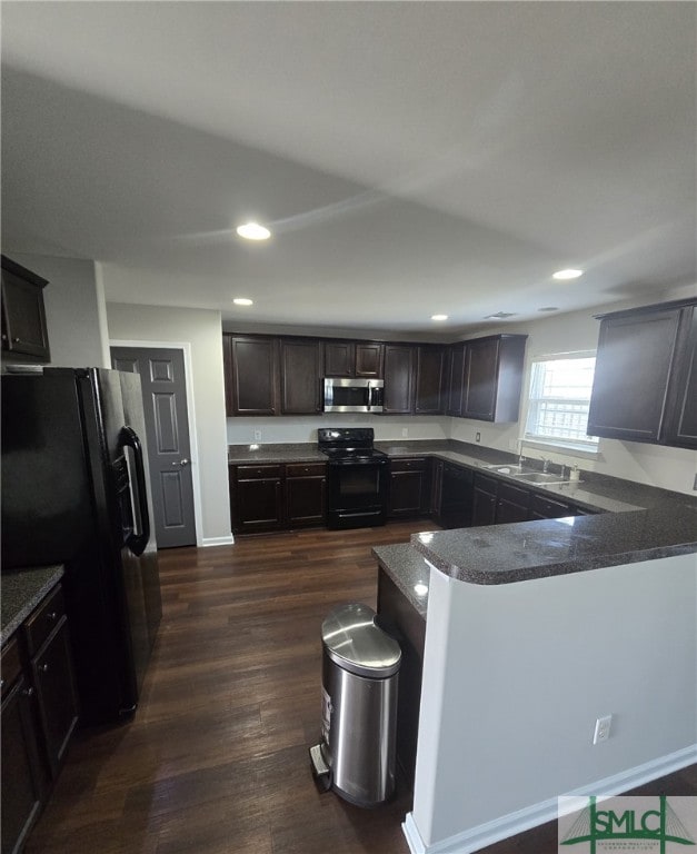 12 Noble Jones Ct, Port Wentworth, GA 31407 - kitchen with dark wood-style flooring, dark brown cabinets, a sink, recessed lighting, and black appliances