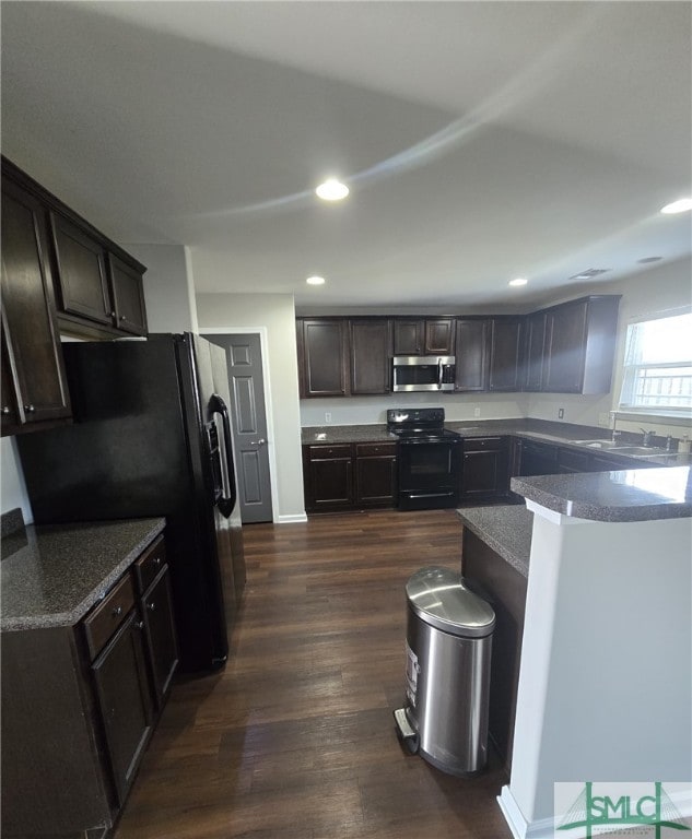 12 Noble Jones Ct, Port Wentworth, GA 31407 - kitchen with recessed lighting, black appliances, dark wood-style floors, and dark brown cabinets