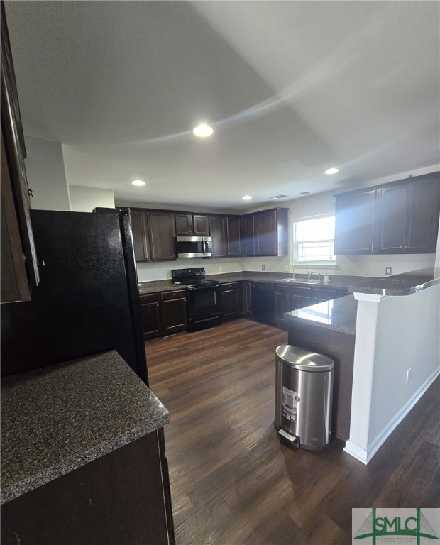 12 Noble Jones Ct, Port Wentworth, GA 31407 - kitchen featuring dark wood finished floors, dark brown cabinets, a sink, black appliances, and recessed lighting