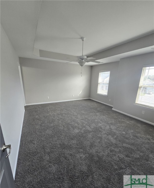 12 Noble Jones Ct, Port Wentworth, GA 31407 - spare room featuring a ceiling fan, baseboards, a wealth of natural light, and dark carpet
