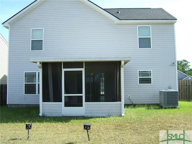 12 Noble Jones Ct, Port Wentworth, GA 31407 - rear view of property with a lawn, fence, central AC unit, and a sunroom
